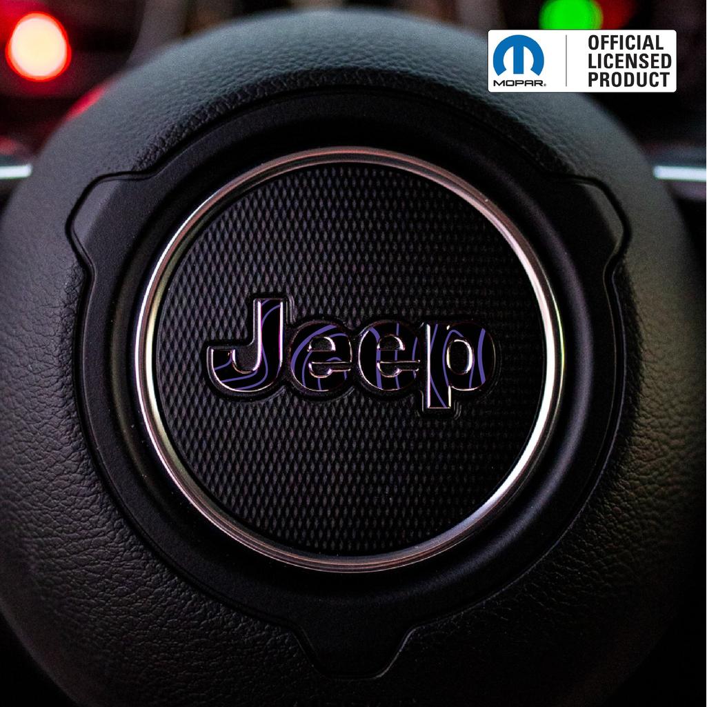 Close-up of a purple topo Jeep logo on a steering wheel with Mopar branding.
