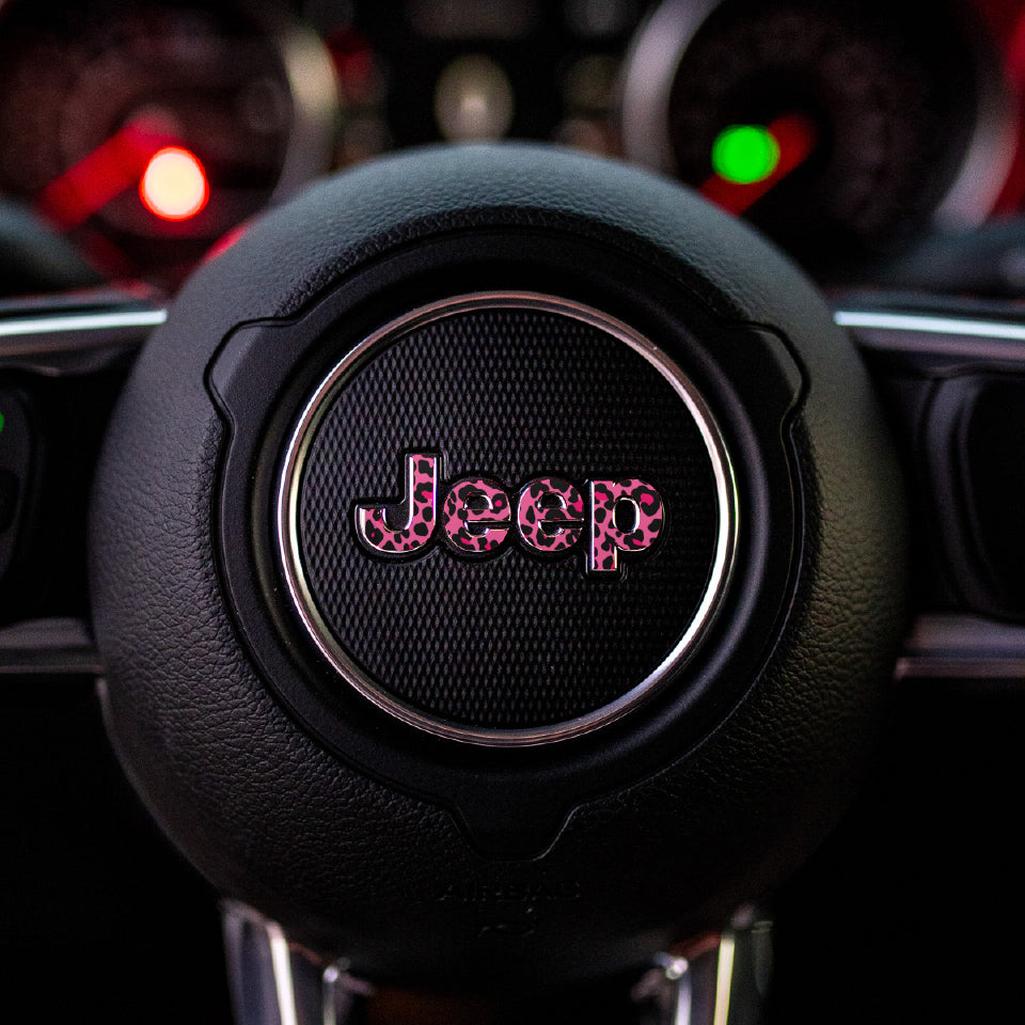 Close-up of a pink leopard Jeep steering wheel with pink leopard print logo