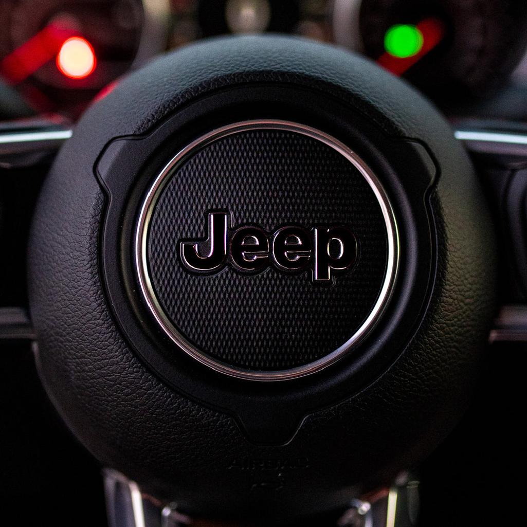 Close-up of a Jeep steering wheel with logo