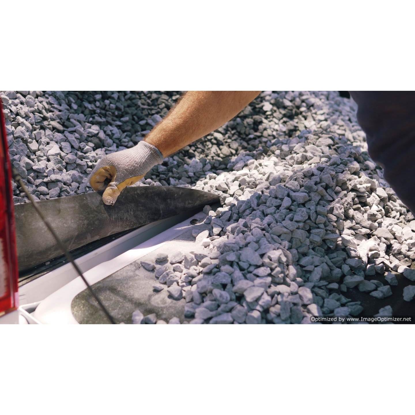 Visual proof of the GapShield’s effectiveness, with hands lifting the cover to show a clean separation between the truck bed and tailgate, devoid of rocks or debris.