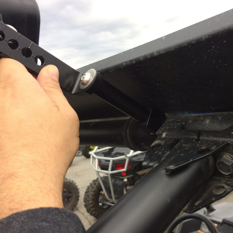 Hand adjusting a black S&B 3" Spacer Kit for Particle Separator