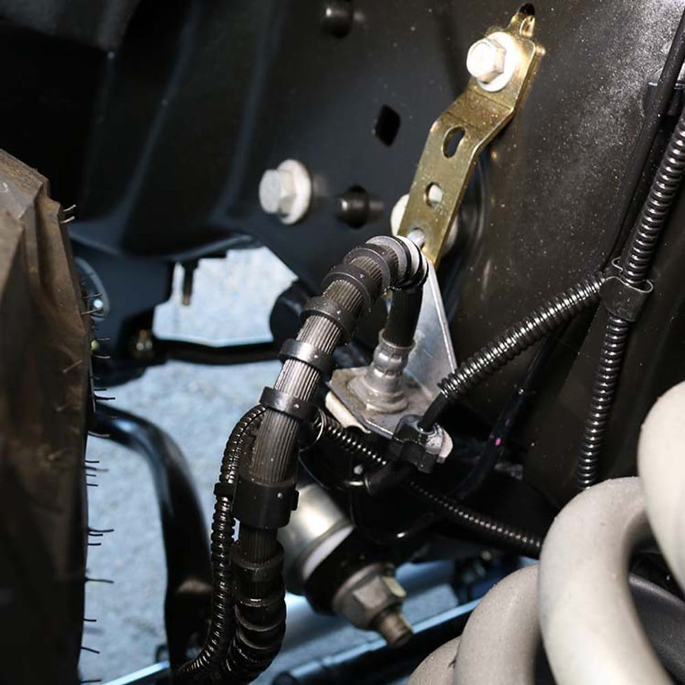 Close up of an S&B Brake Line Drop Bracket Kit, Up to 4.5" Drop installed in a car