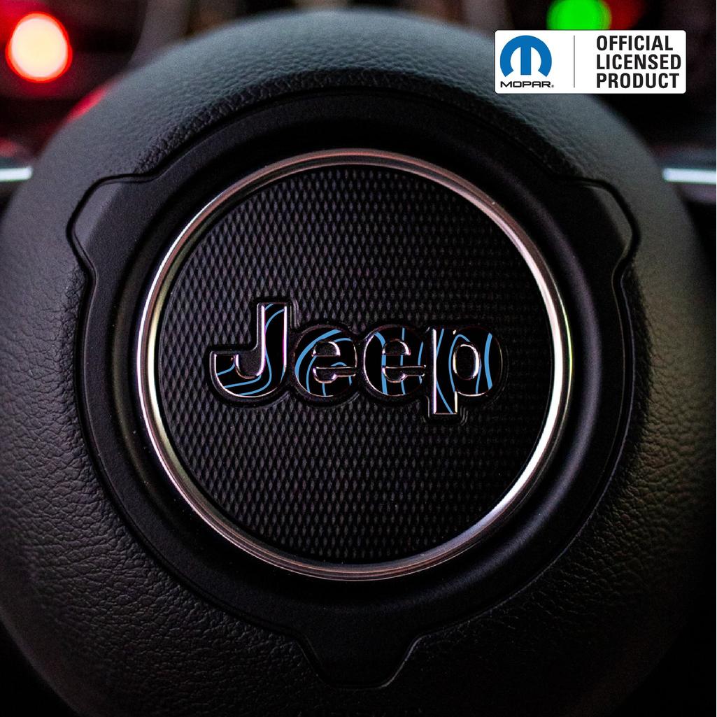 Close-up of a blue topo Jeep logo on a steering wheel with Mopar branding.