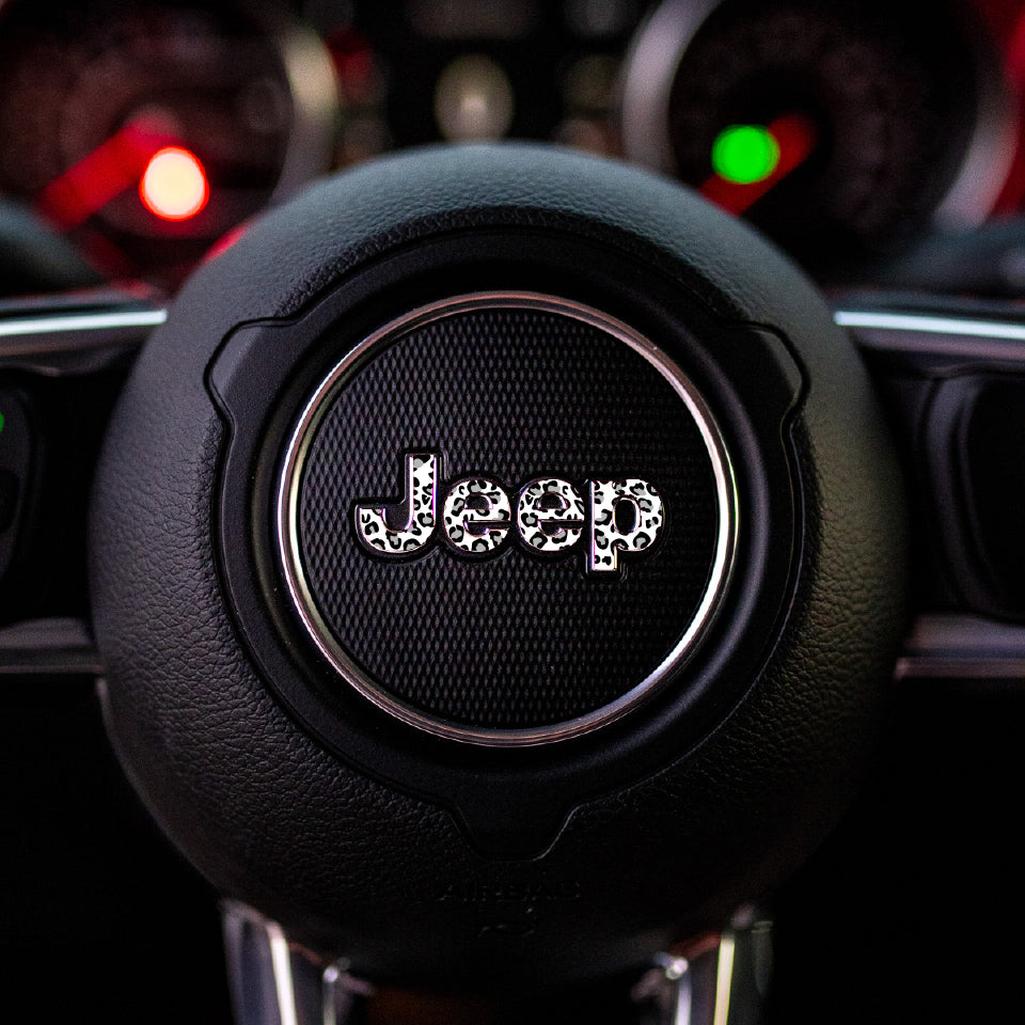 Close-up of a black and white leopard Jeep steering wheel with logo