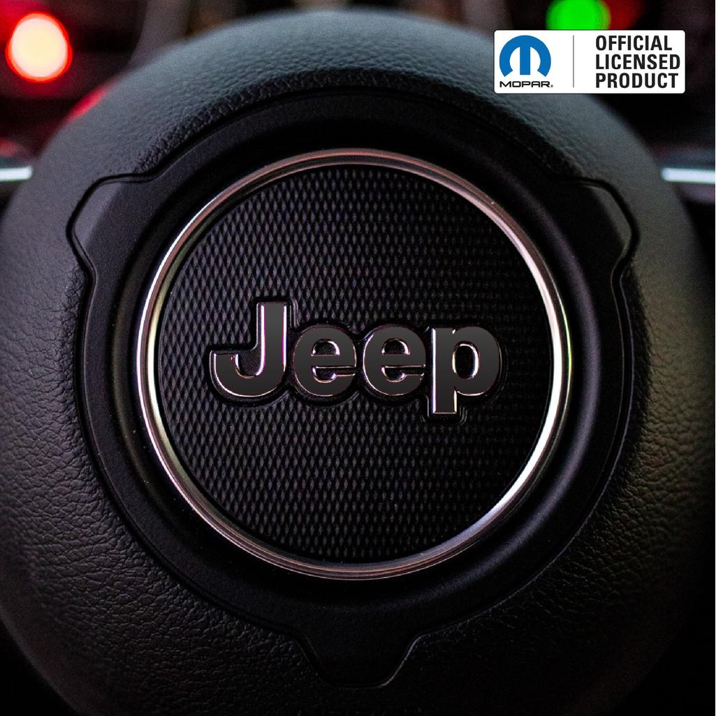 Close-up of a Jeep logo on a steering wheel with Mopar branding.