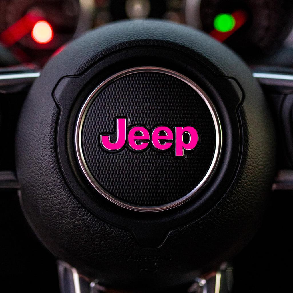 Steering wheel with Jeep logo in pink on a dark background