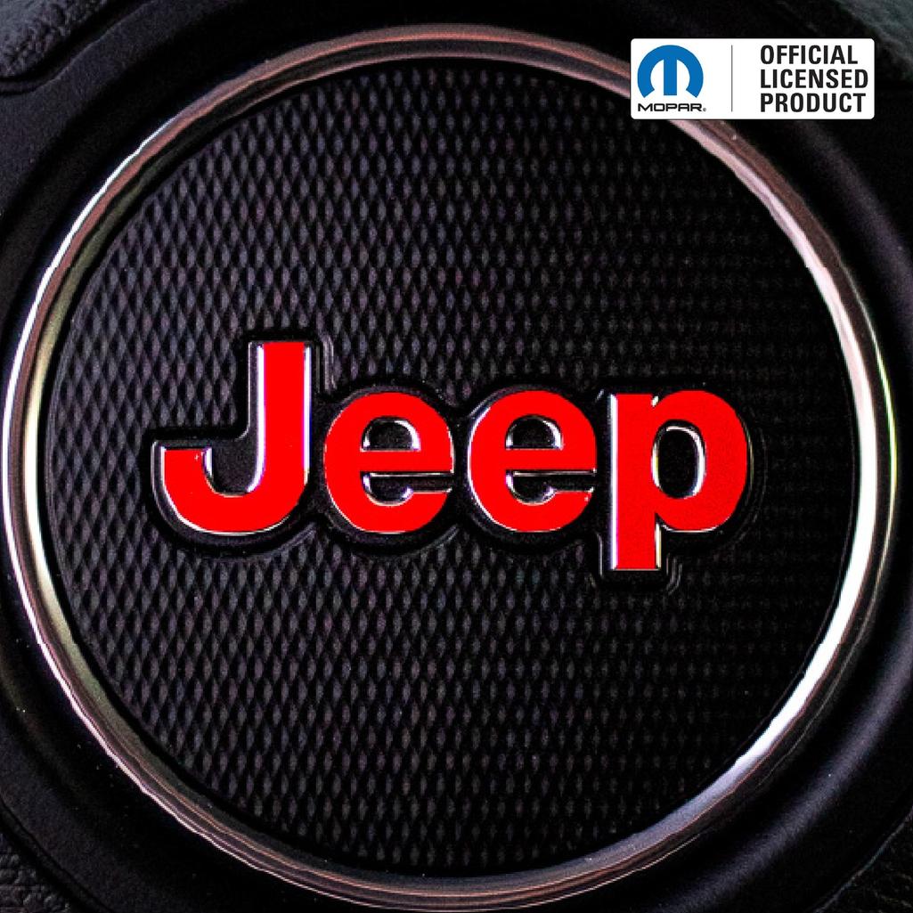 Close-up of a Jeep logo on a textured surface with Mopar branding. Steering wheel