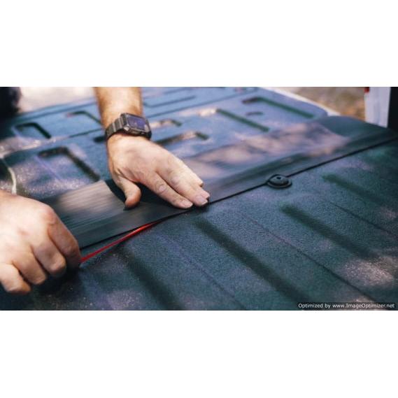 "Photo of hands effortlessly installing the GapShield Universal Tailgate Gap Cover on a truck bed, illustrating the simple, no-tools-required setup